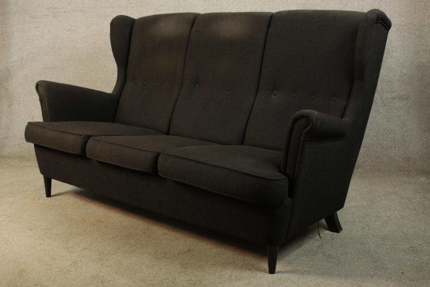 A contemporary black upholstered three person button back and scroll arm sofa raised on tapering - Image 3 of 4