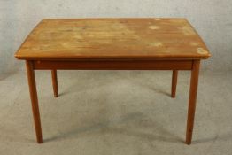 A mid 20th century Danish style teak draw leaf dining table raised on tapering supports. H.72 W.
