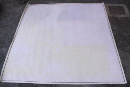 A contemporary white woollen carpet. L.390 W.376cm.