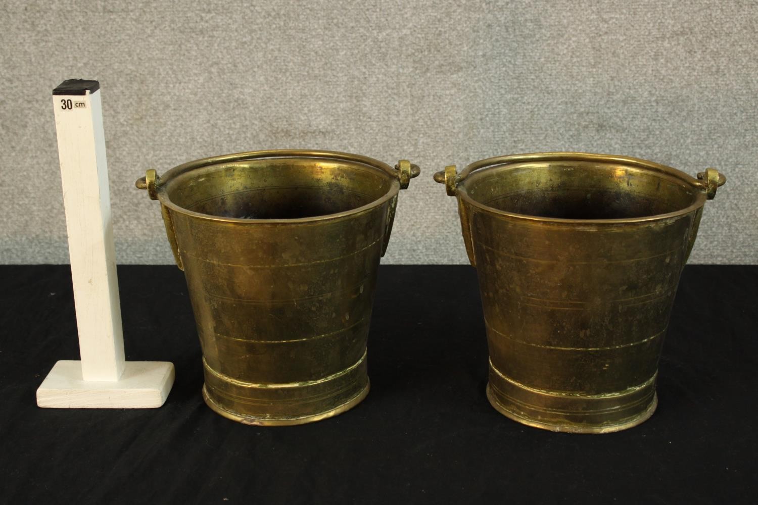 A pair of early 20th century brass buckets, each with swing handles and raised on circular foot. - Image 2 of 2