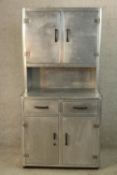 A mid 20th century aluminium coated kitchen cupboard with twin cupboard doors above two drawers