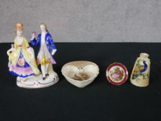 Four pieces of 20th century porcelain to include a Limoges pin dish decorated with a courting