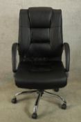 A contemporary black upholstered and chrome framed open arm adjustable office chair raised five
