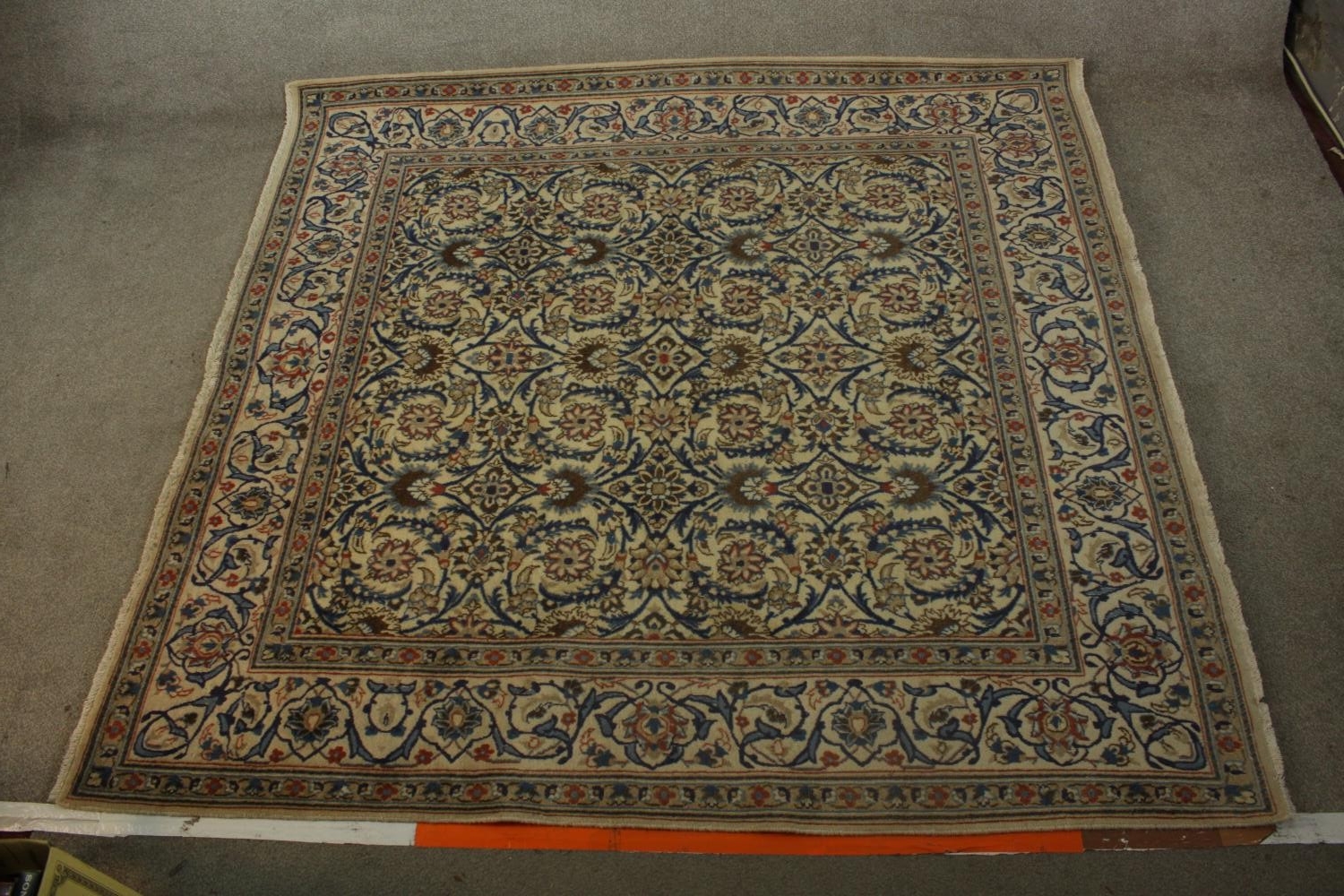 An 20th century Persian woollen carpet with all over floral and scroll decoration. L.203 W.194cm.