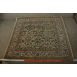 An 20th century Persian woollen carpet with all over floral and scroll decoration. L.203 W.194cm.