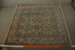 An 20th century Persian woollen carpet with all over floral and scroll decoration. L.203 W.194cm.
