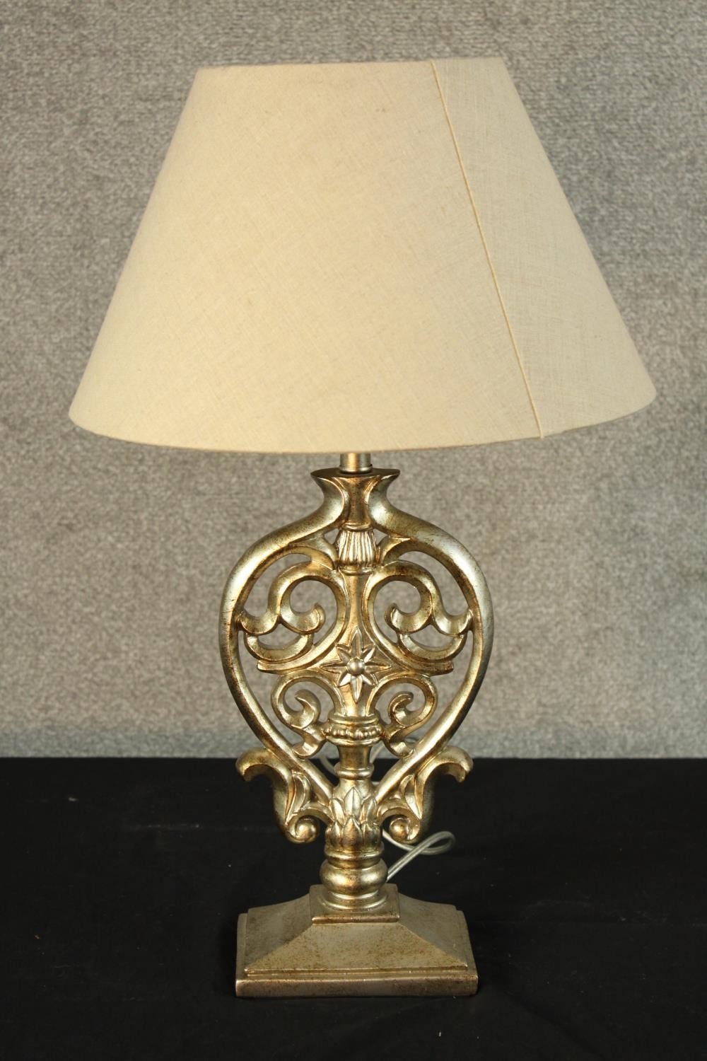 A contemporary Italian silver painted carved and pierced hardwood table lamp raised on rectangular