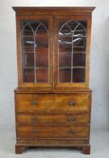 A 19th century mahogany twin glazed door secretaire bookcase opening to reveal adjustable shelves