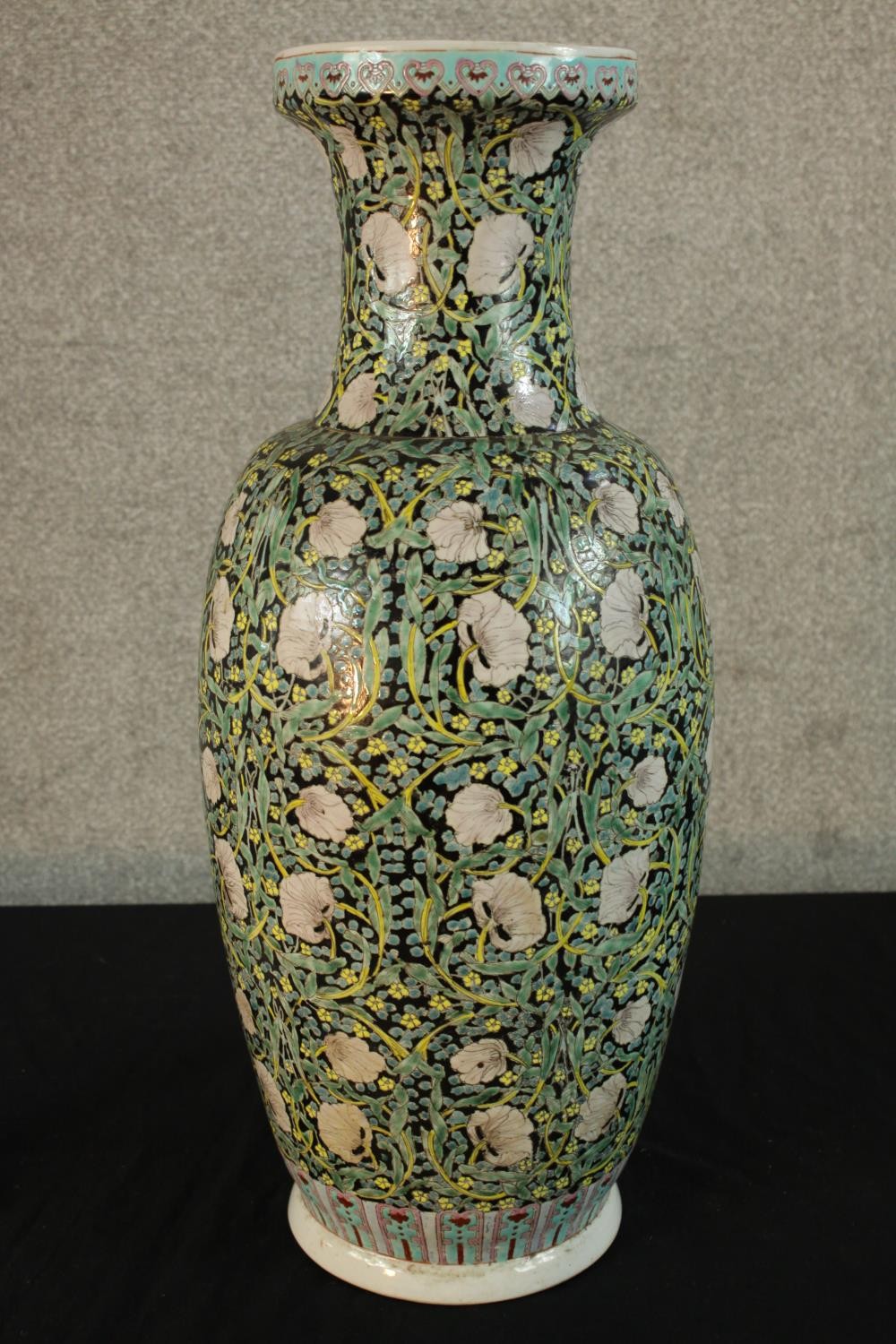 A late 19th century Chinese Famille Noire porcelain baluster vase, with floral decoration, six