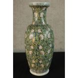 A late 19th century Chinese Famille Noire porcelain baluster vase, with floral decoration, six