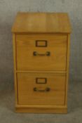 A contemporary beech two drawer filing cabinet raised on plinth base. H.70 W.44 D.48cm.