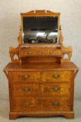 A late 19th/early 20th century pine mirror back dressing chest with three long drawers raised on