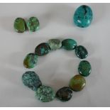 A collection of Turquoise beads, the largest bead measures 4.5cm. H.13 W.13cm largest