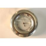 A contemporary Georg Jensen chrome plated circular air pressure gauge. H.16 W.15cm.