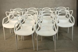 A set of ten Kartell Masters style white moulded stackable chairs.