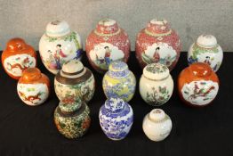 A pair of 20th century Chinese porcelain ginger jars and covers, decorated with characters in a