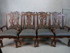 A set of eight mahogany framed pierced splat back dining chairs with stuff over seats raised on