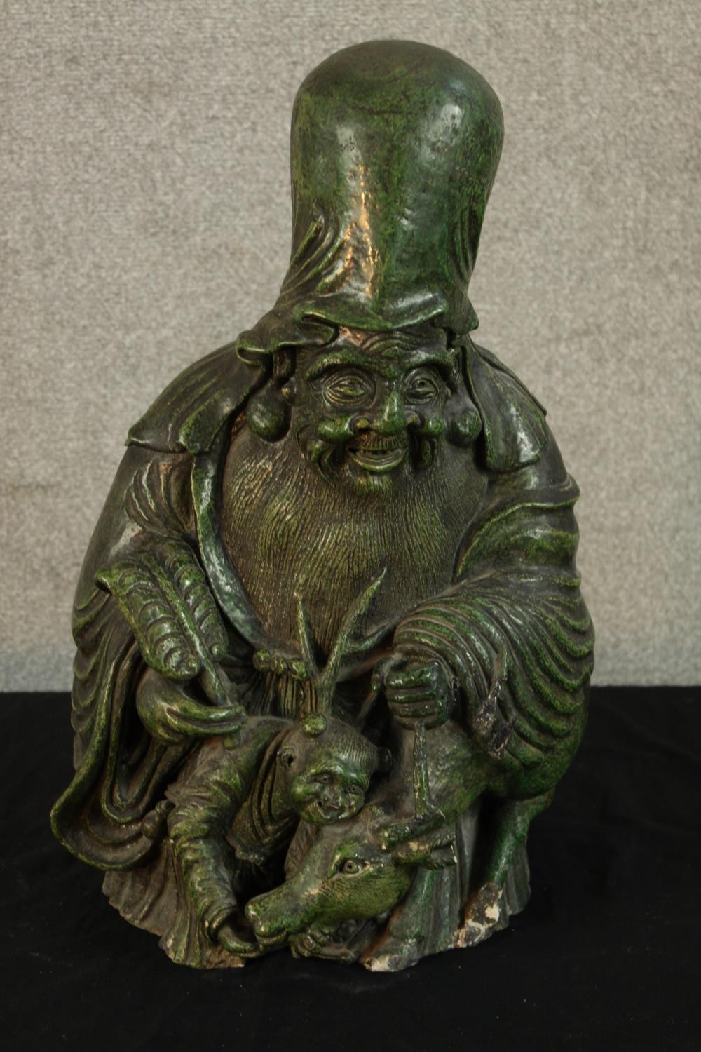 A 19th/early 20th century Chinese green painted porcelain figure of Shao Lao with animals and