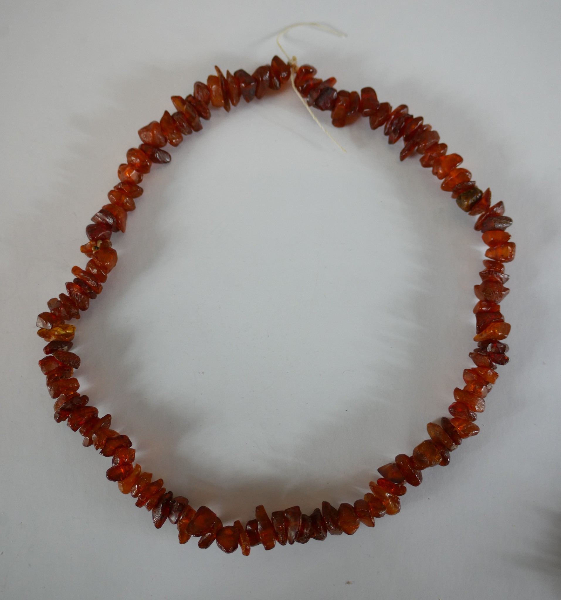 Four strings of polished natural amber chips. H.21 W.24cm largest - Image 3 of 5
