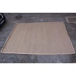 A contemporary beige cotton woven rug. L.375 W.270cm.