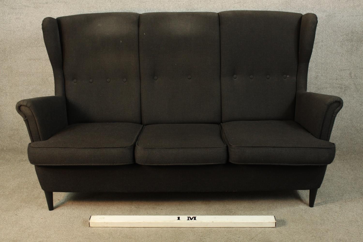 A contemporary black upholstered three person button back and scroll arm sofa raised on tapering - Image 2 of 4