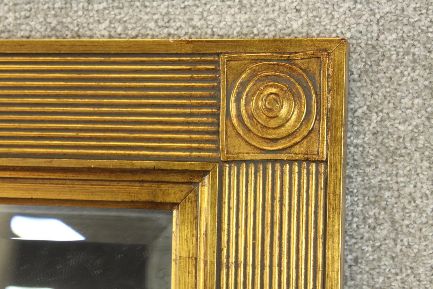 A contemporary 20th century guilded rectangular wall mirror with reeded decoration. H.140 W.110cm. - Image 3 of 7