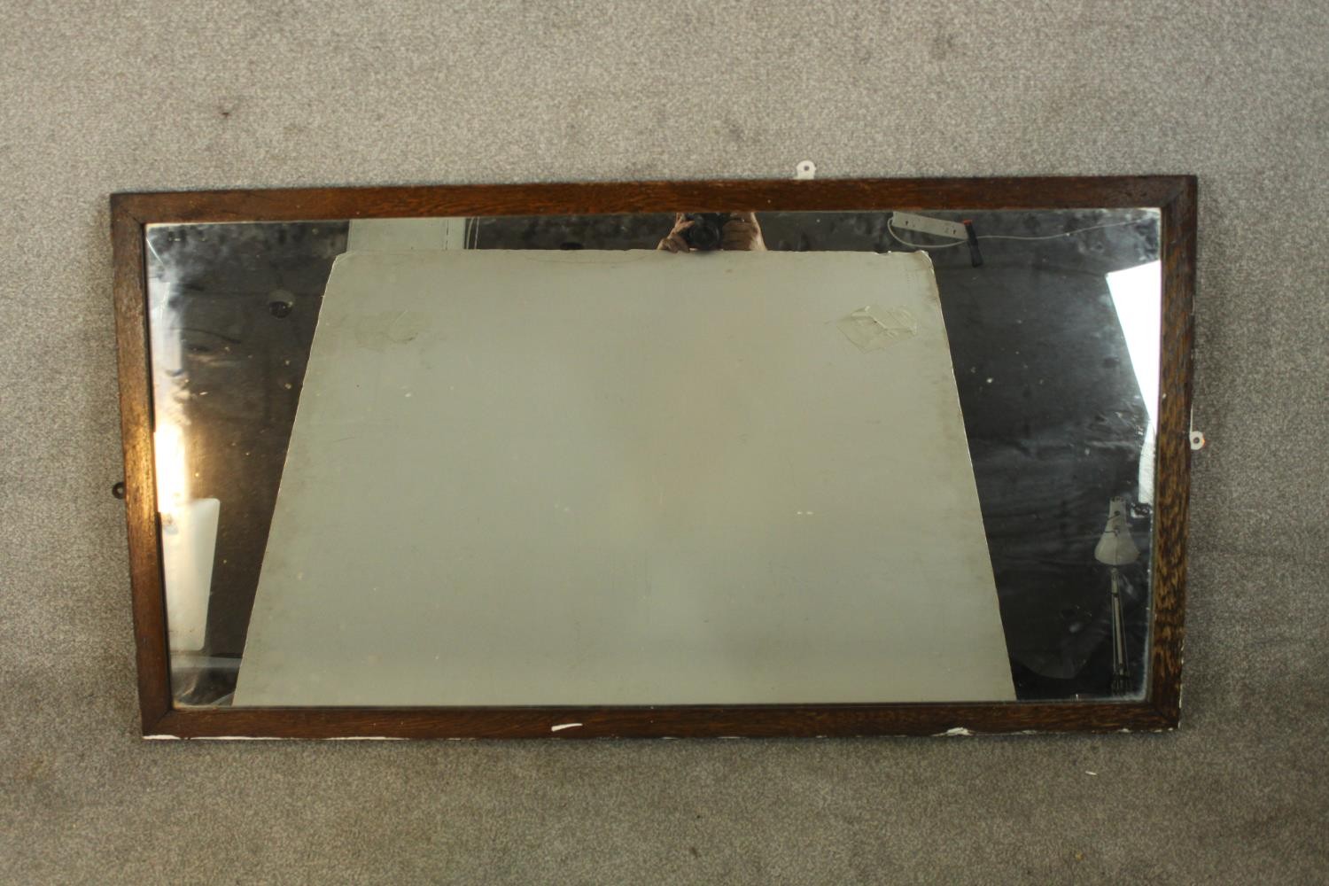 An early 20th century oak framed rectangular wall mirror. H.67 W.132cm.