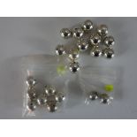 A collection of twenty one round polished white metal beads (tests as silver), various sizes. H.2