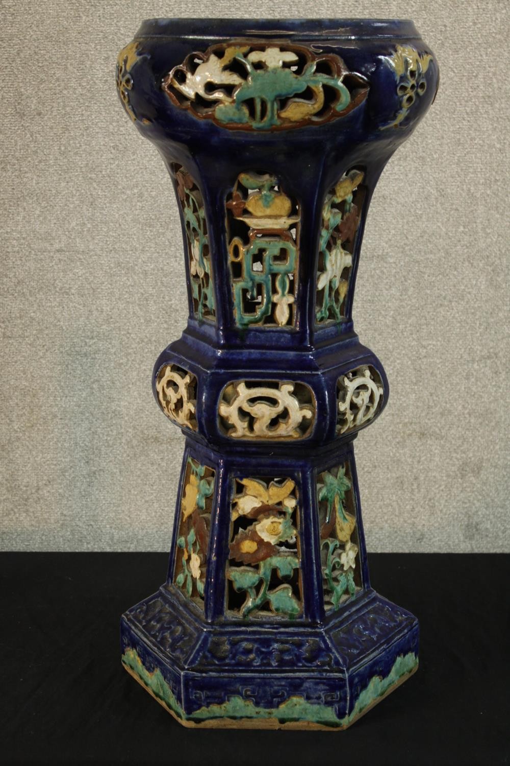 A 19th century Majolica tapering Gu shaped shaped floor standing pottery planter, raised on