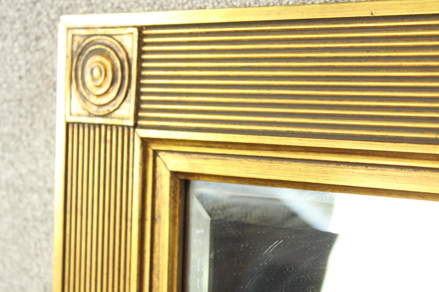 A contemporary 20th century guilded rectangular wall mirror with reeded decoration. H.140 W.110cm. - Image 4 of 7