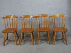 A set of 20th century pine kitchen chairs raised on splayed turned supports.