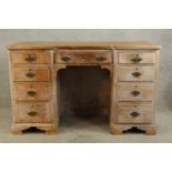 A 20th century limed hardwood twin pedestal desk with central drawer and twin pedestals each with