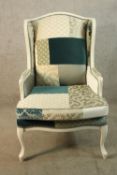 A late 19th/early 20th century white painted French style armchair with patchwork upholstered