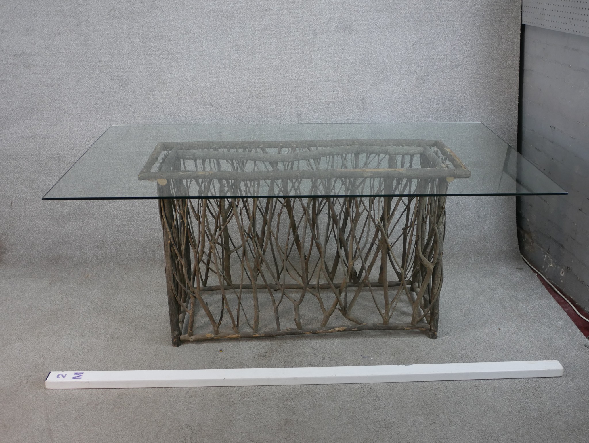 A contemporary glass topped table raised on modernist rectangular twig base. H.77 W.180 D.100cm - Image 4 of 5