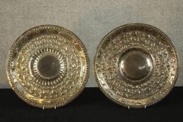 Two late 19th/early 20th, possibly Indian white embossed white metal chargers.. Dia.40cm. (each)