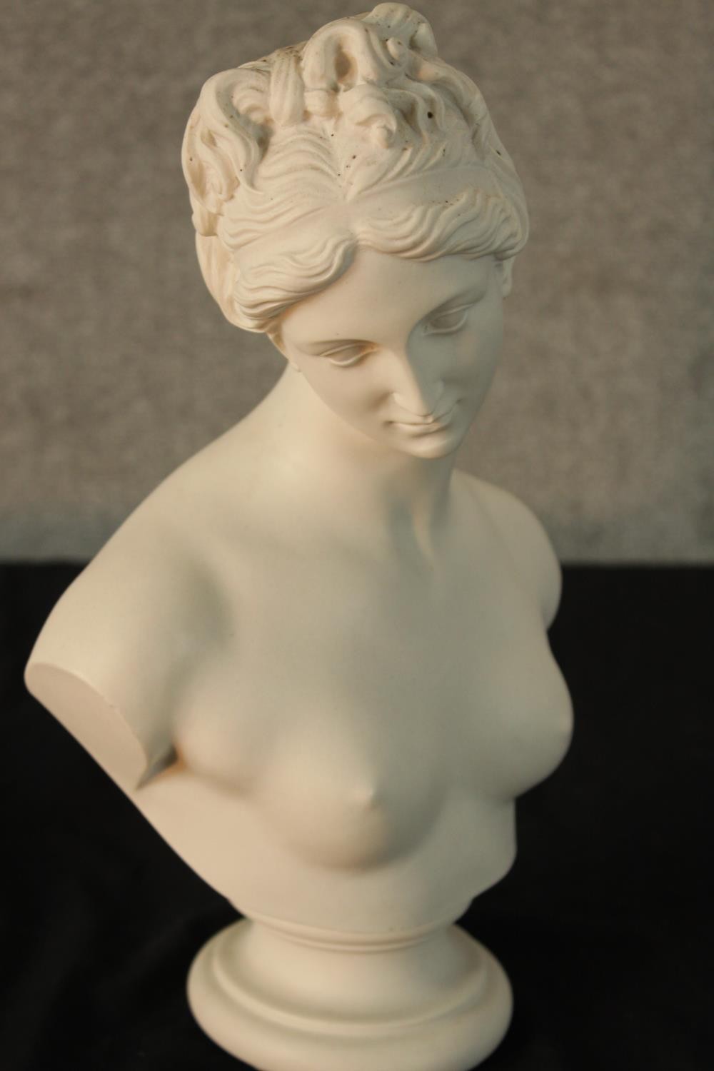 An early 20th century painted porcelain bust of a semi clad classical lady raised on turned socle - Image 3 of 4