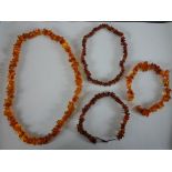 Four strings of polished natural amber chips. H.21 W.24cm largest
