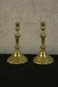 A pair of French Louis XV brass octagonal candlesticks raised on octagonal bases. H.24cm.