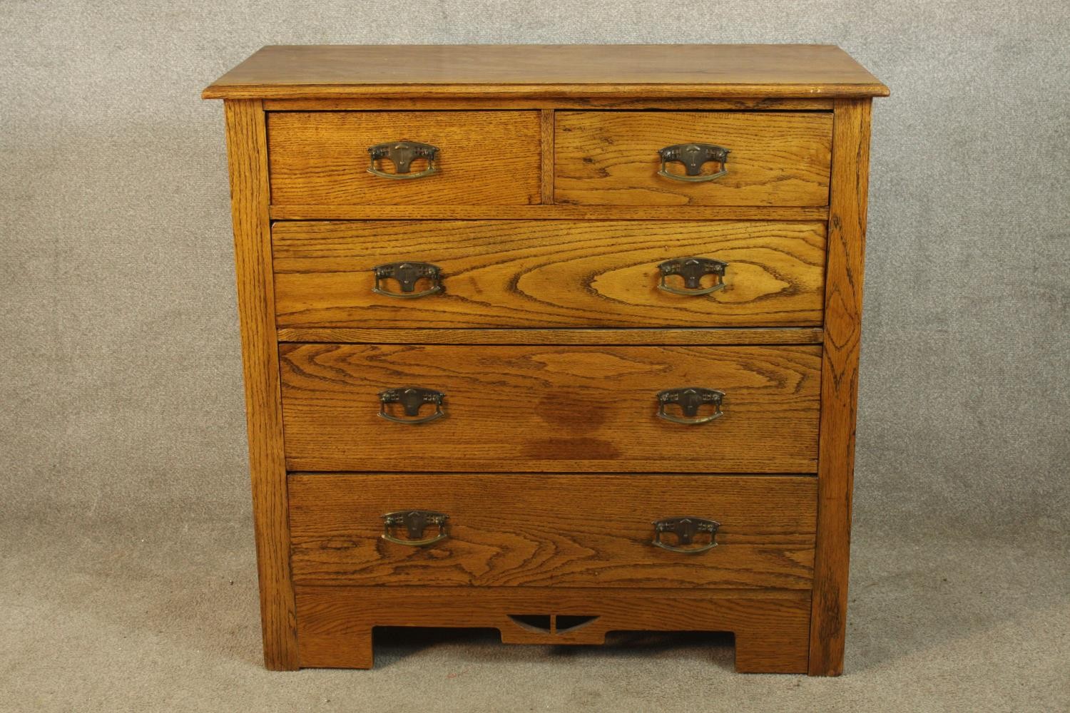 A late 19th/early 20th Art Nouveau style pine chest of two short over three long drawers with