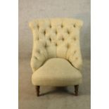 A Victorian style teak framed cream button back low nursing chair raised on turned supports H.89cm.