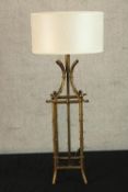 A contemporary brass table lamp cast in the form of sticks of bamboo raised on four splayed