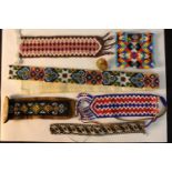 A collection of seven pieces of Danish beadwork, each with geometric patterns. L.56cm. (largest0