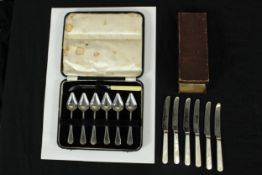 A cased set of six mother of pearl handled knives, together with a cased set of six silver plated