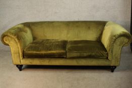 A 20th century scroll arm two seater settee raised on turned supports. H.73 W.200cm.