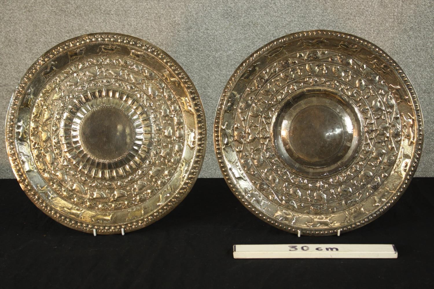 Two late 19th/early 20th, possibly Indian white embossed white metal chargers.. Dia.40cm. (each) - Image 2 of 3