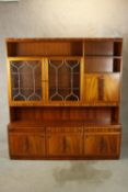 A large contemporary mahogany effect dresser/cabinet with shelf back and two glass doors with drinks