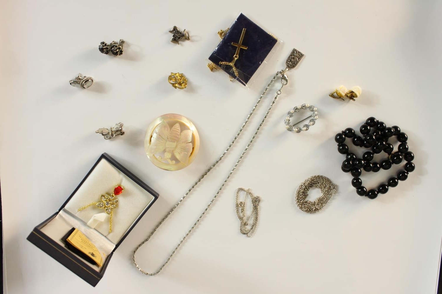 A collection of mixed jewellery, including a silver filigree wirework butterfly brooch, a black