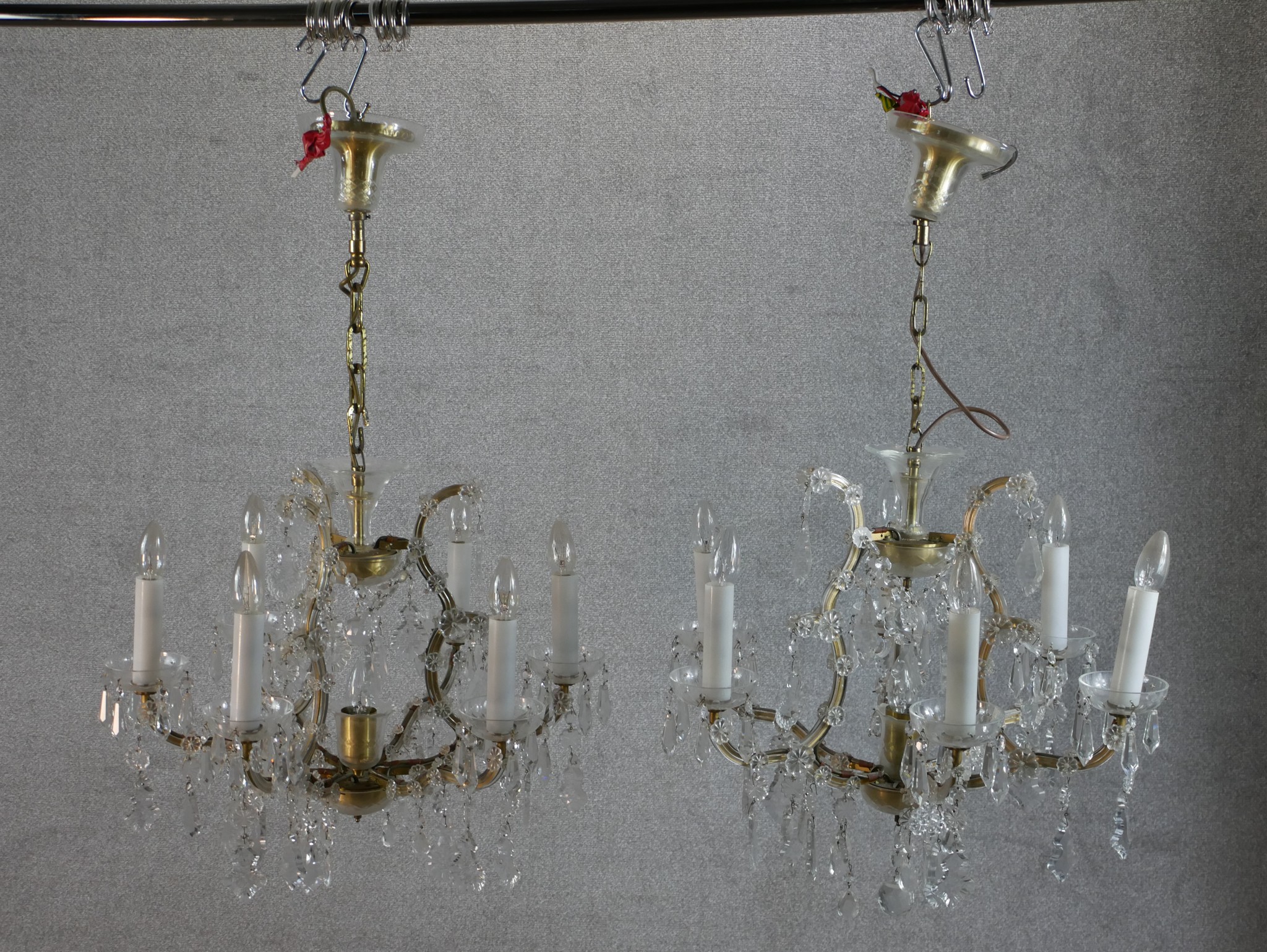 A matched pair of 20th century cut glass six branch hanging electroliers. H.97 W.63 D.63cm