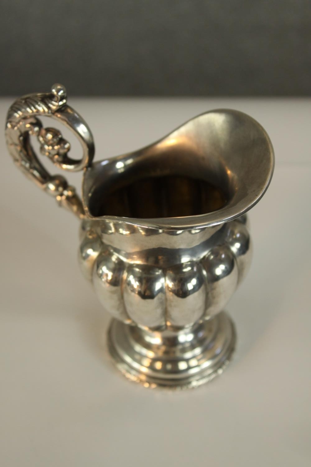 A 19th century Swedish hallmarked silver jug, with cast acanthus leaf scroll work handle, the half - Image 3 of 4