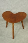 A mid 20th century teak heart shaped occasional table raised on three splayed supports. H.39cm.